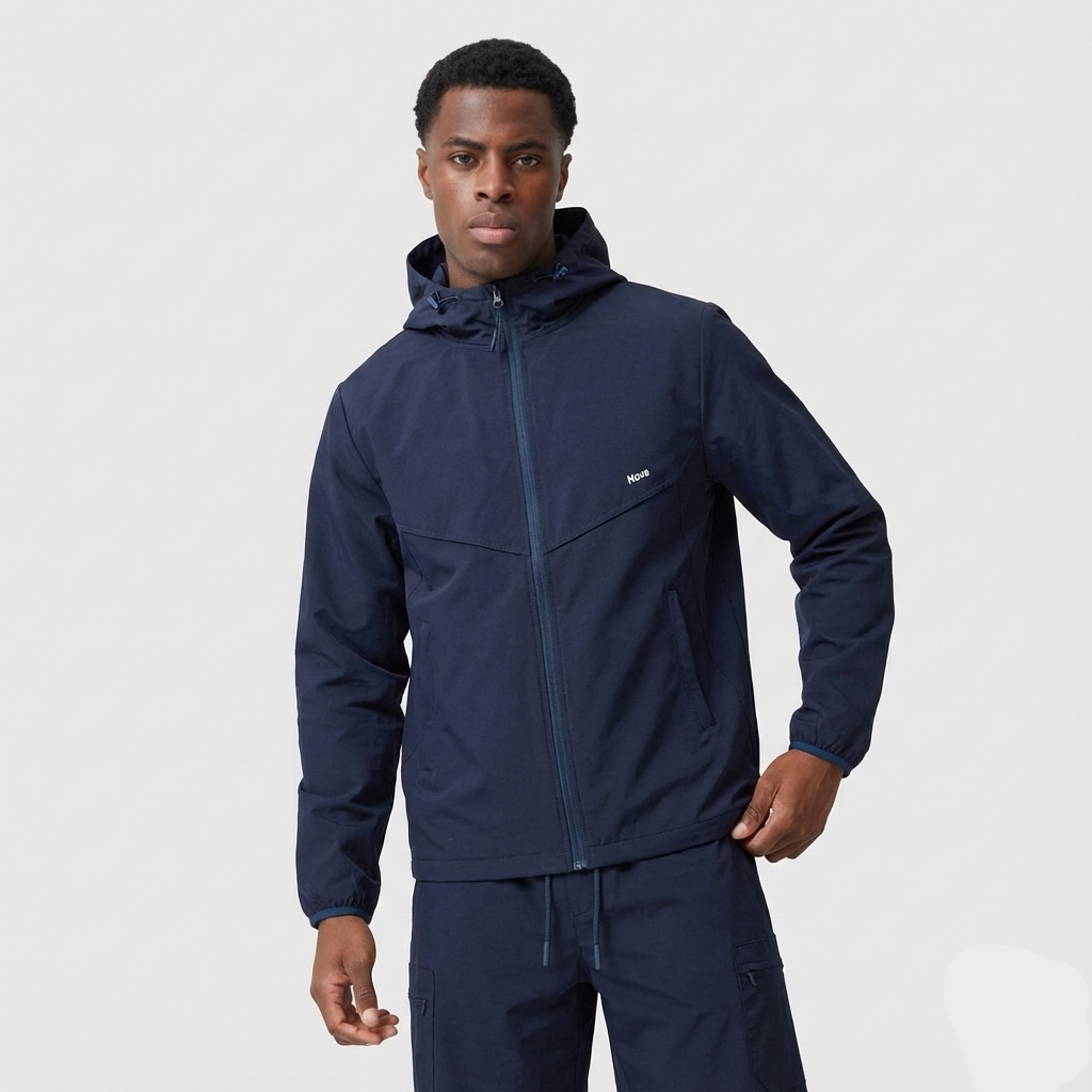 Man wearing a navy blue jacket and pants on a light gray background