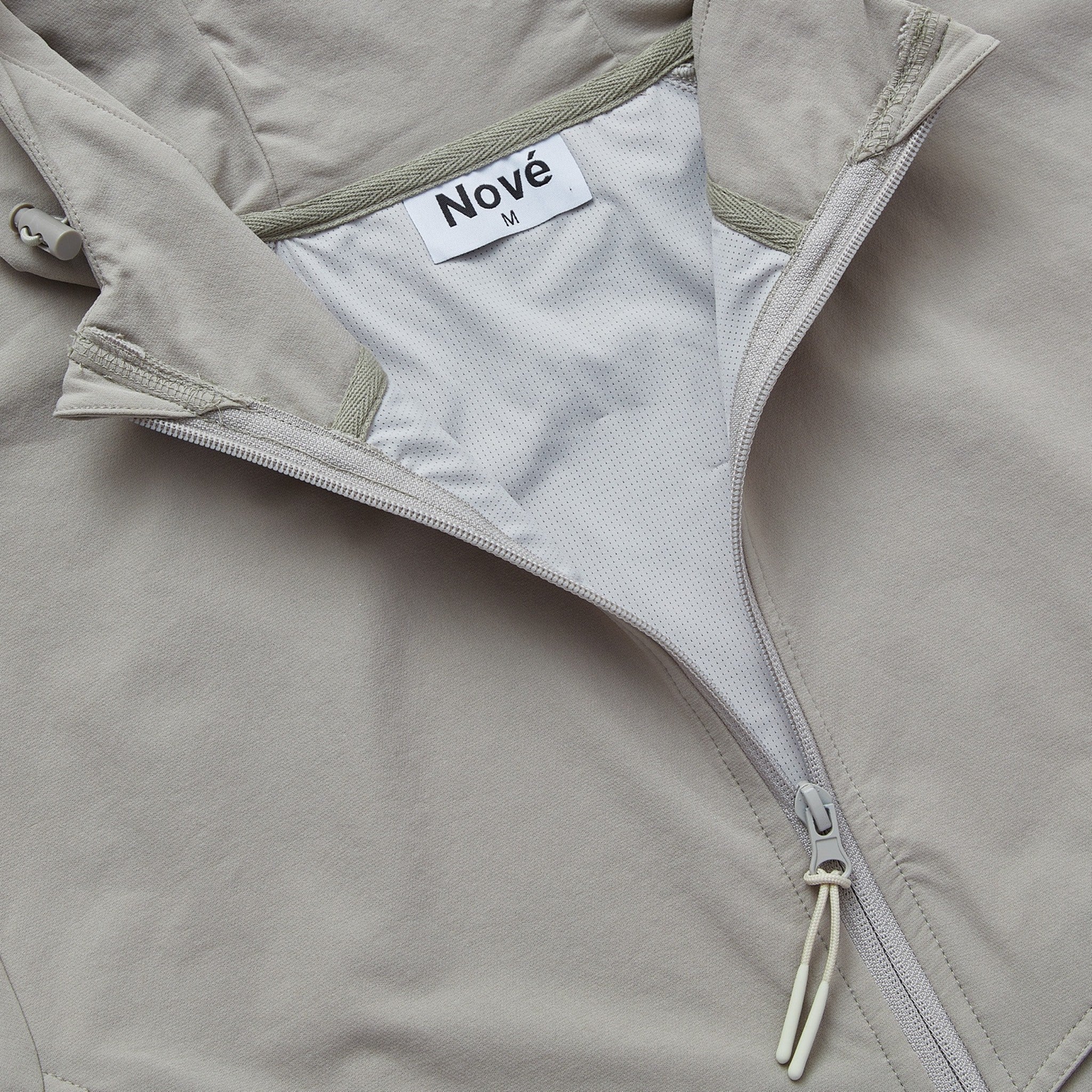 Close-up of Nové label inside grey core windbreaker jacket