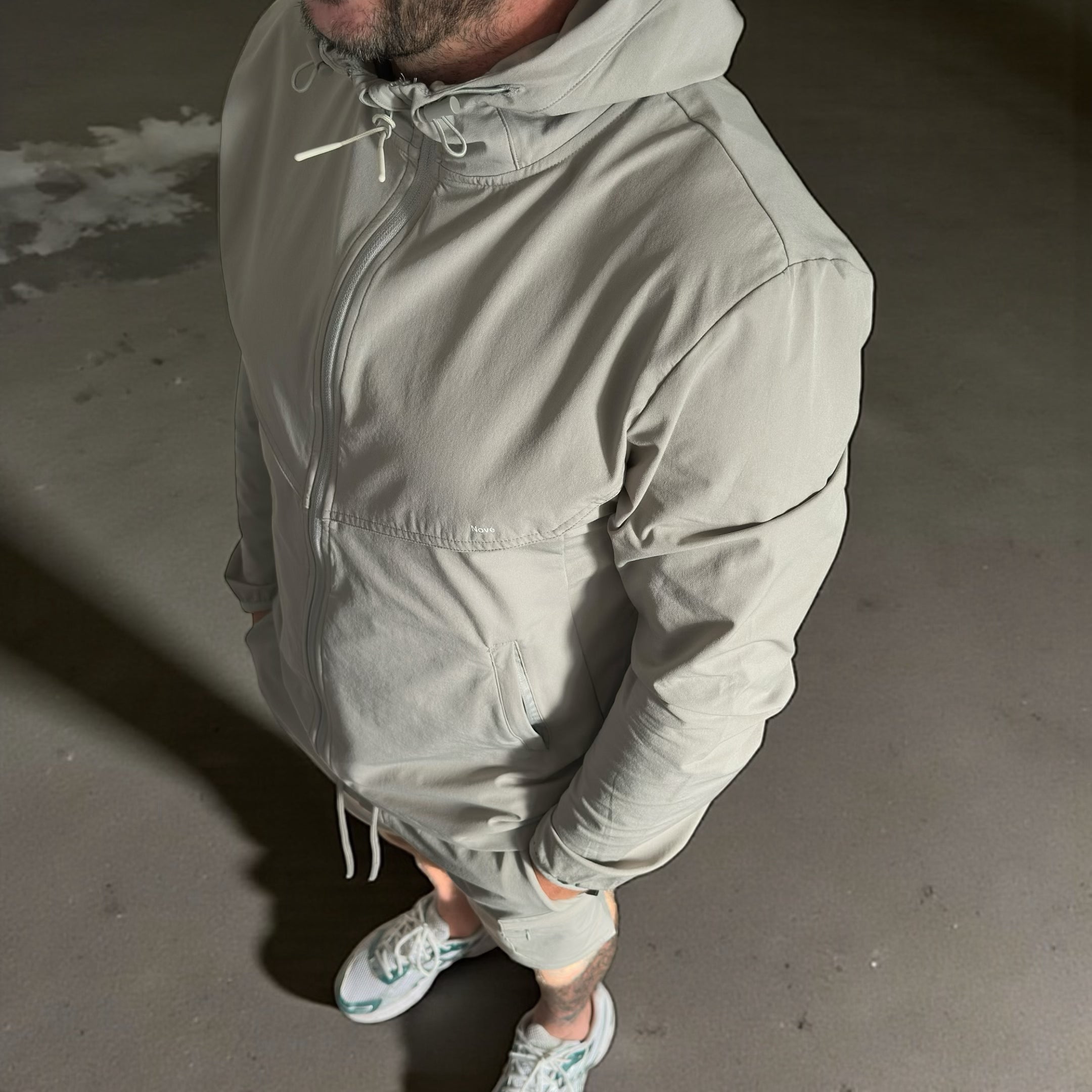 model wearing nove grey windbreaker