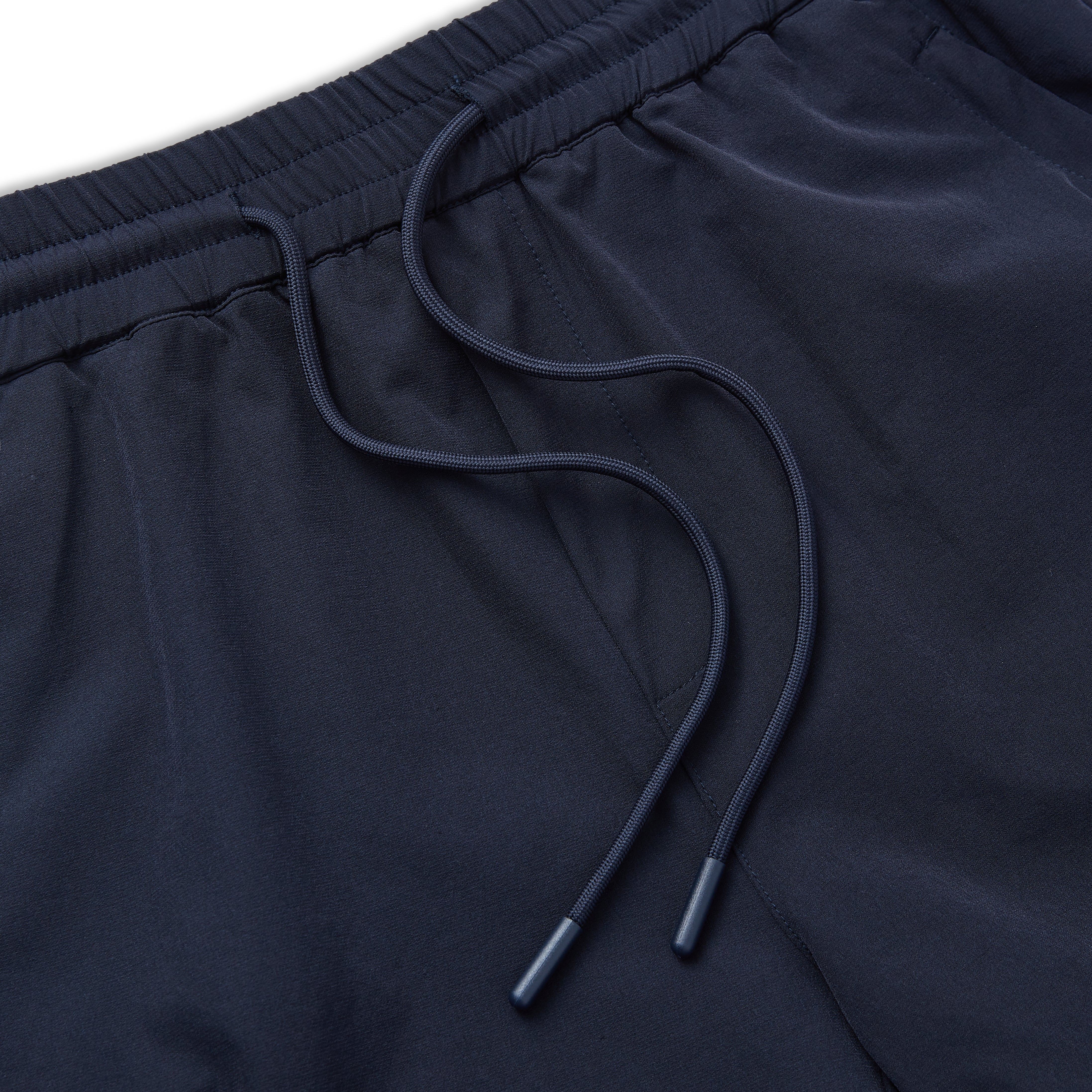 Navy blue shorts with drawstring on a white background