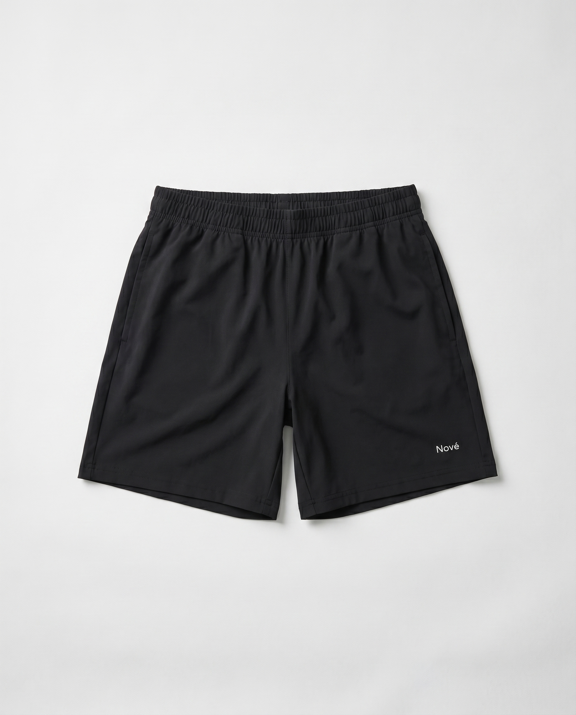 Black shorts with a brand logo on a light gray background