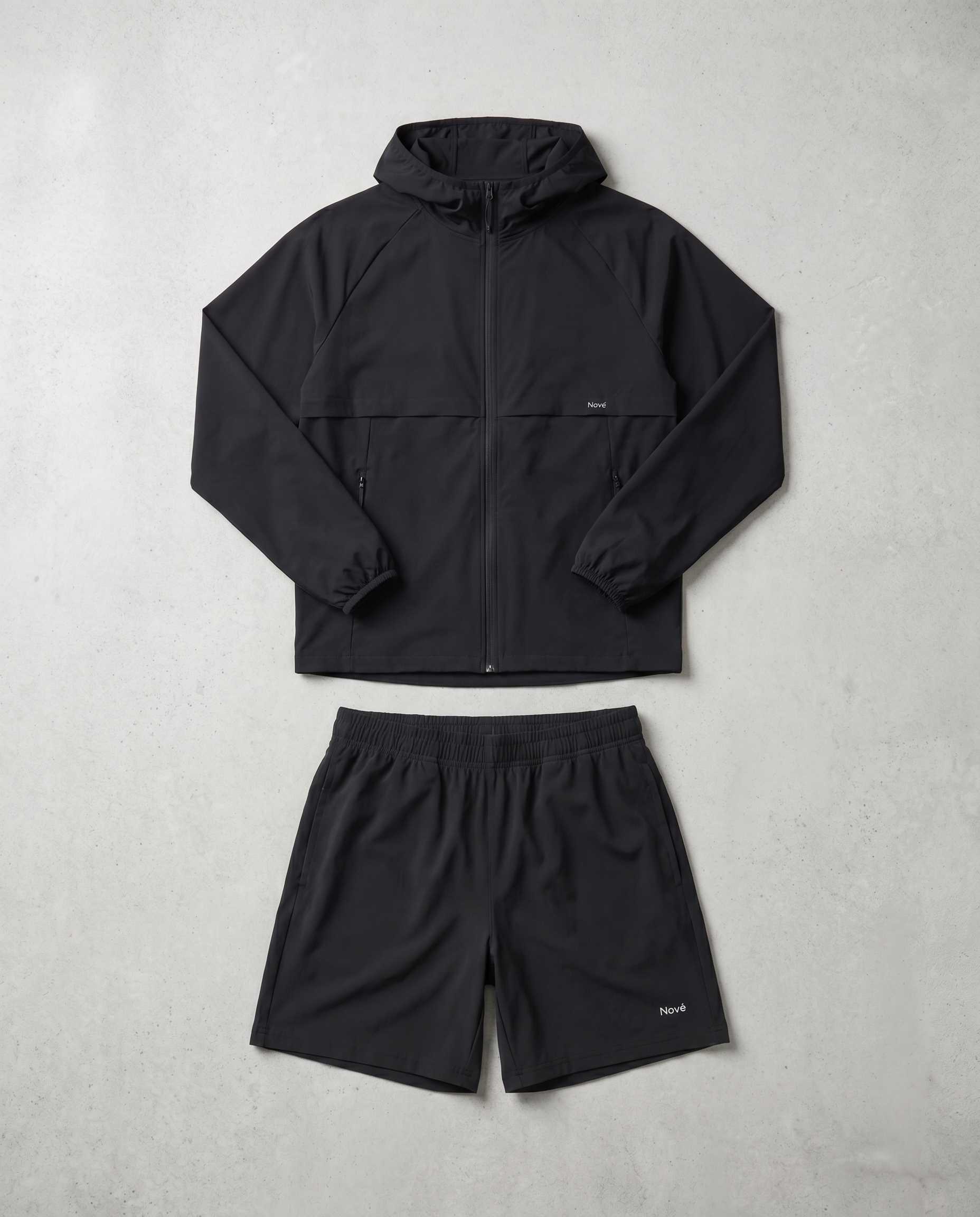 Black jacket and shorts set on a light gray background