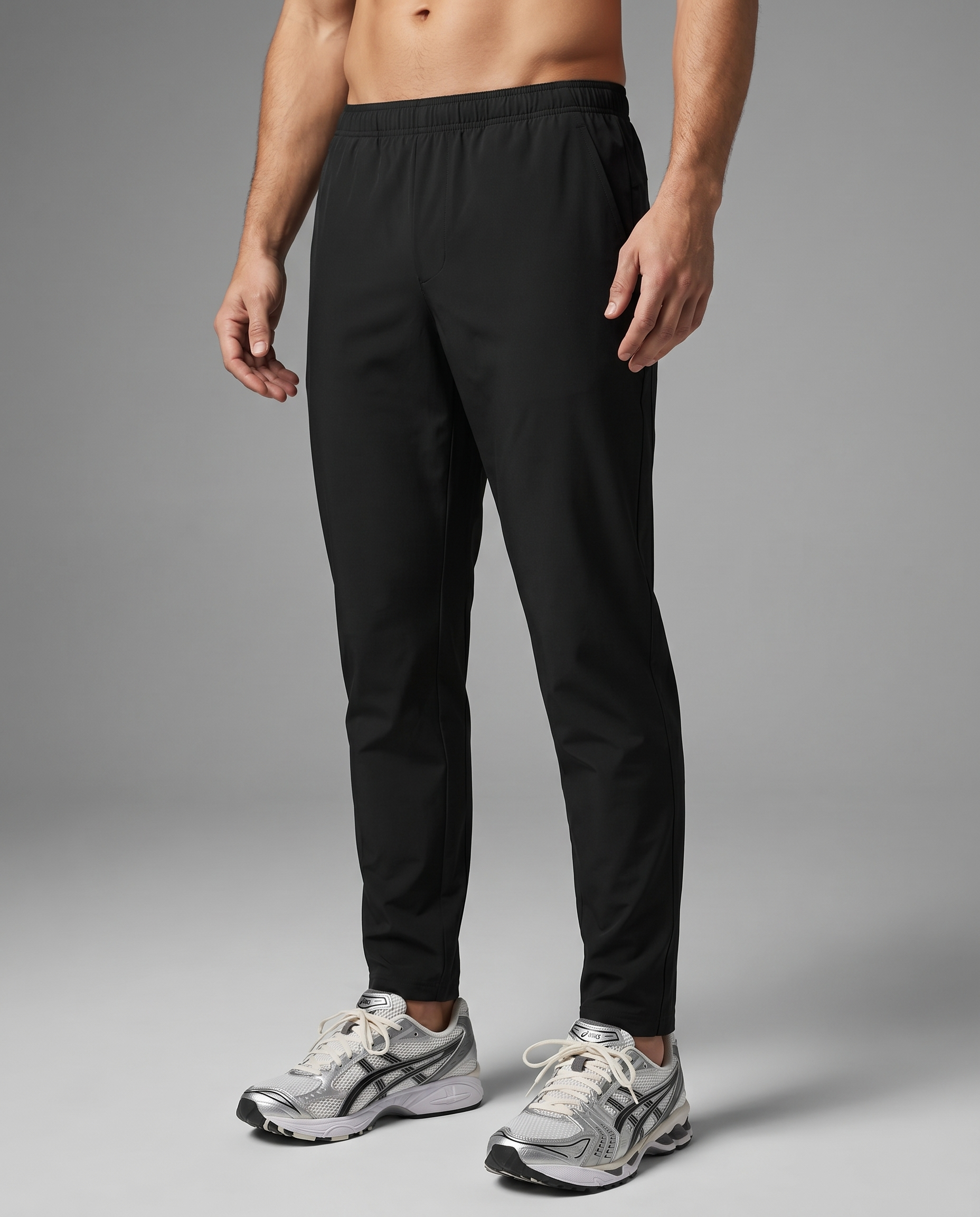 man wearing black motion pants on a light grey background
