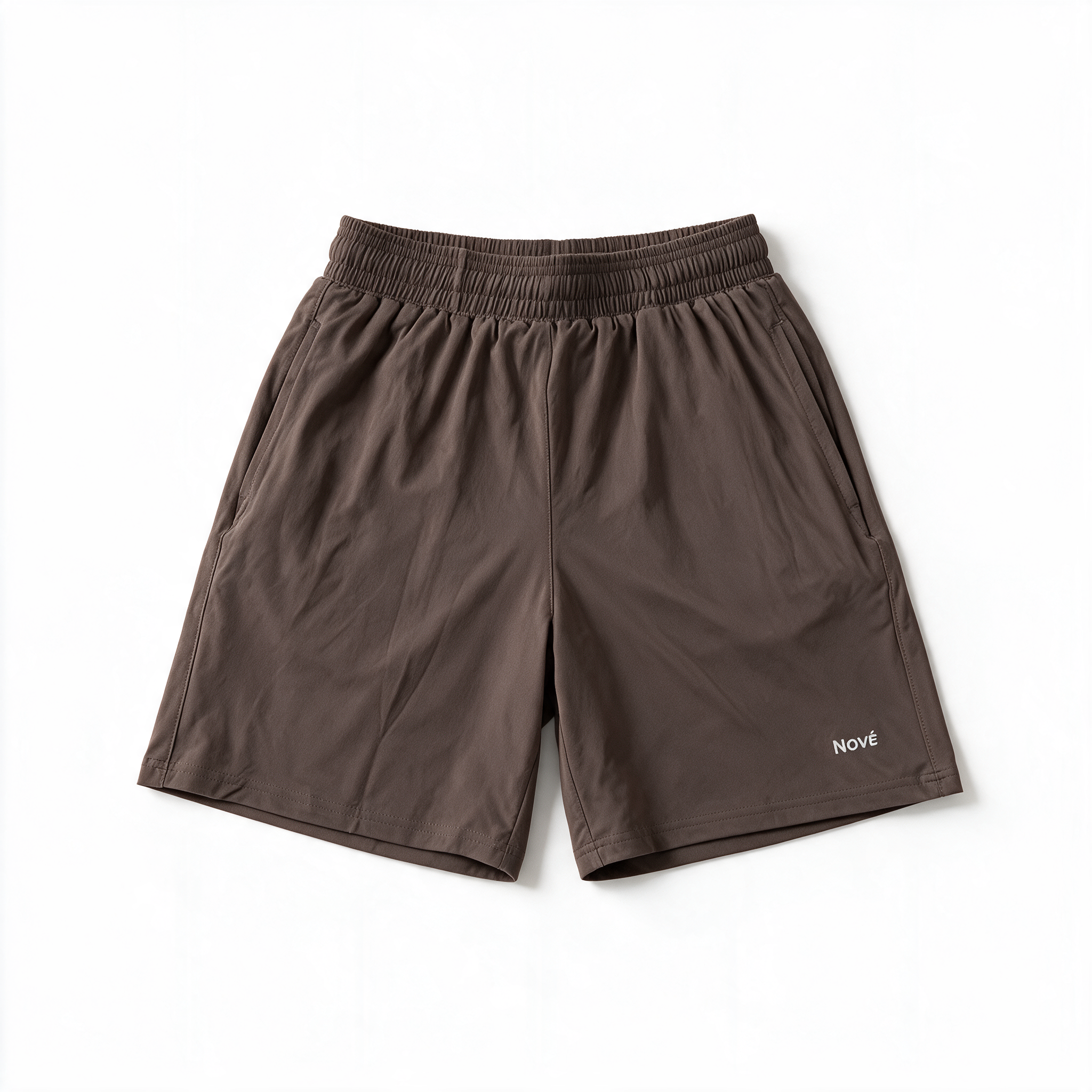 A pair of dark brown athletic shorts with an elastic waistband and a small white 'NOVE' logo on the lower left hem, displayed flat against a white background.