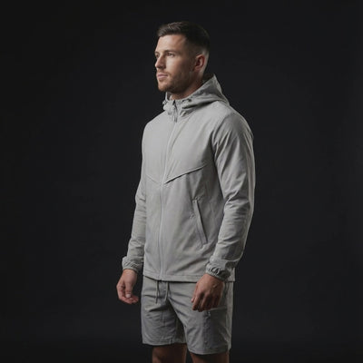 video of a male wearing grey windbreaker set